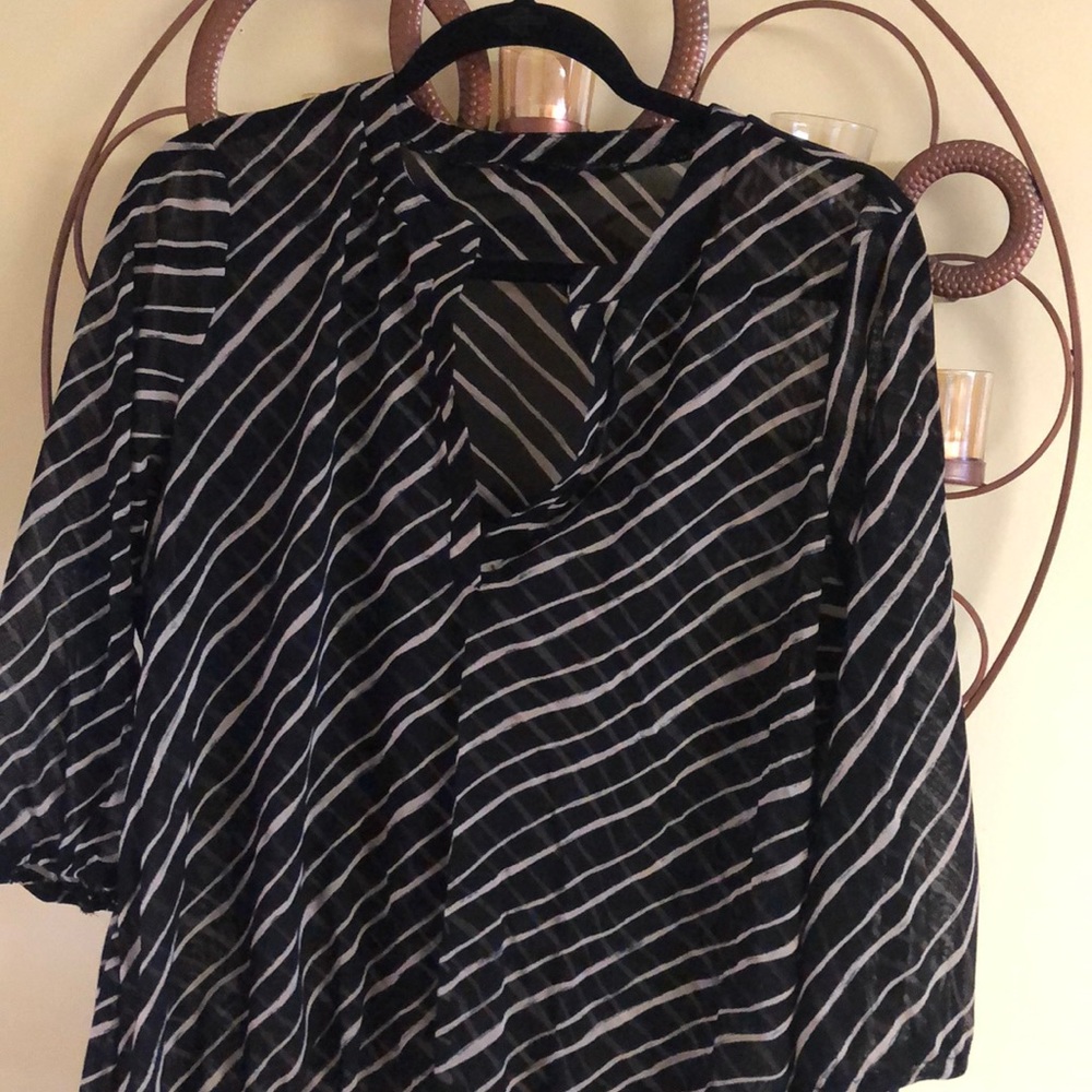 The limited sheer black tan strips top
